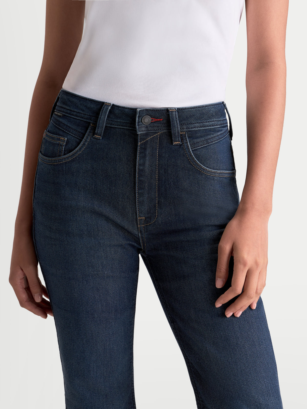 Alpinestars Stella Flex-AST 7 Denim Pants, women's motorcycle riding jeans in dark blue, close-up view of the five-pocket chassis and waist fit worn by a model
