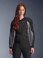 Alpinestars Woman Stella Troop-Air Jacket, Women's Motorcycle Mesh Jacket, Black Ash Gray and Pink Fluo, worn by a model with matching riding pants, featuring ventilated 2D tech mesh construction and pink logo detail, designed for urban summer riding.