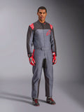 Alpinestars KMX-9 V3 Graphic 6 Karting-Anzug, Grau und Anthrazit mit roten Akzenten, mit einer einzigartigen Splash-Grafik auf der Brust und den Beinen, kombiniert mit roten Rennhandschuhen und schwarzen Karting-Schuhen, Ganzkörper-Studioaufnahme