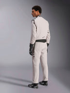 Alpinestars GP Race V3 Suit FIA, Silver Anthracite racing suit, side and back view, worn with black racing gloves and boots, featuring dark gray accents on the waist and shoulders, professional auto racing protective apparel.