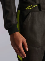Alpinestars GP Race V3 Suit FIA, Auto Racing Suit, Black and Yellow Fluo, close-up view showing the adjustable waistband with yellow star logo, ribbed sleeve cuff, and side stripe detail, professional motorsport gear.