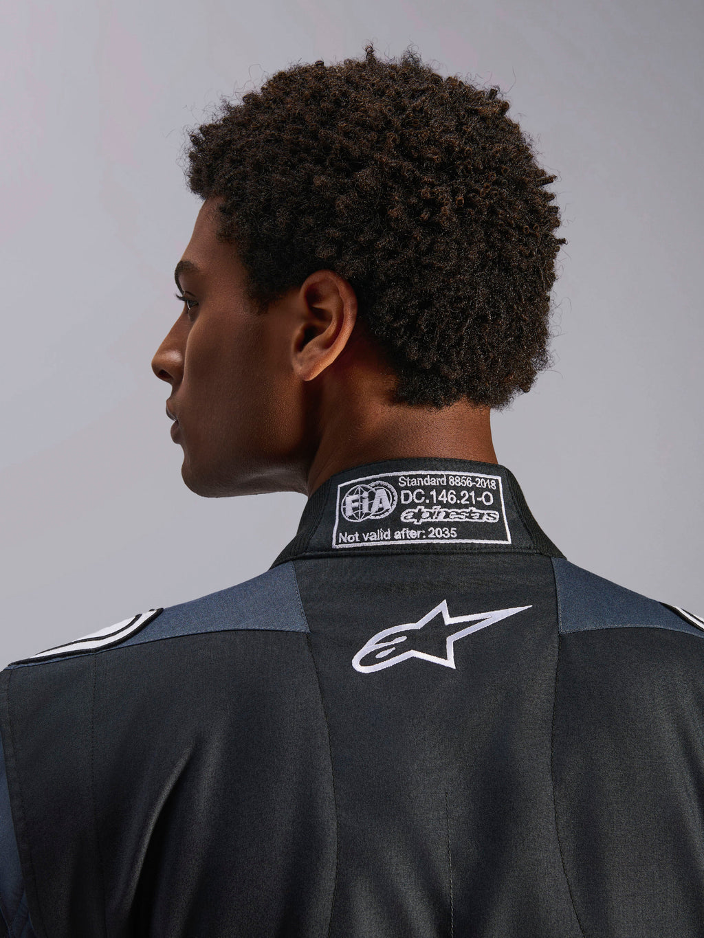 Alpinestars GP Pro Comp V2 FIA Auto Racing Suit, Black and Asphalt, with FIA 8856-2018 certification and white Astar logo.