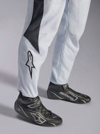 Alpinestars GP Pro Comp V2 FIA Suit, Gray and Black Auto Racing Suit with leg star logo and racing boots.
