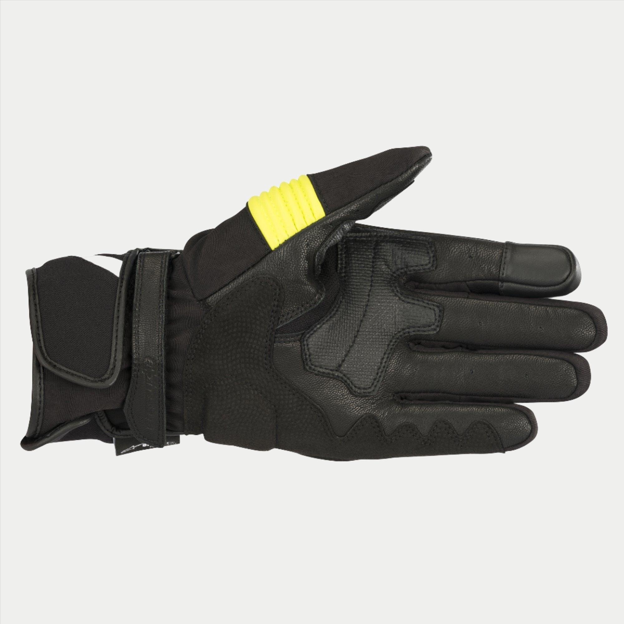 Alpinestars T-SP W Drystar® Handschuhe, Schwarz und Gelb Fluo, Handflächenansicht mit Ziegenlederkonstruktion, neongelbe Akzente am Daumen, touchscreen-kompatible Fingerspitzen, doppelter Klettverschluss am Handgelenk.