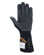Alpinestars Tech-1 ZX V4 Gloves, Auto Racing Gloves, Black and Orange Fluo, palm view showing 3D silicone grip patterning and honeycomb texture, FIA and SFI homologation labels visible on the cuff, professional motorsport gear