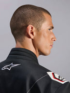 Alpinestars Kart Indoor V2 Suit, Black, close-up view of the ergonomic collar and Formula 1-derived shoulder design, featuring white Alpinestars logo and racing-inspired details on durable twill fabric