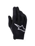 Alpinestars Supertech MX Gloves, Motocross Gloves, Black and White, backhand view featuring a large white Astars logo, laser-cut perforations for ventilation, and a seamless ergonomic design for off-road racing