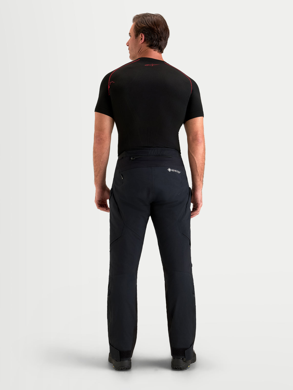 Alpinestars St 7 V 2 2 L Gore Tex Hose Short, Herren-Adventure-Motorradhose in Schwarz, Rückansicht am Model mit wasserdichter Gore-Tex-Membran und passendem schwarzen Oberteil