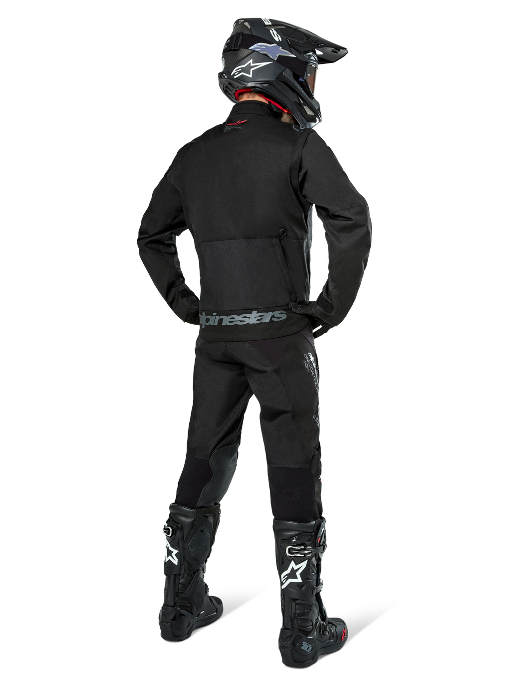 Alpinestars Pro-Dura Jacket, Black Off-road Enduro Jacket, rear view worn with matching pants and black Tech 10 boots, featuring prominent Alpinestars branding on the lower back, rugged textile construction for aggressive trail riding