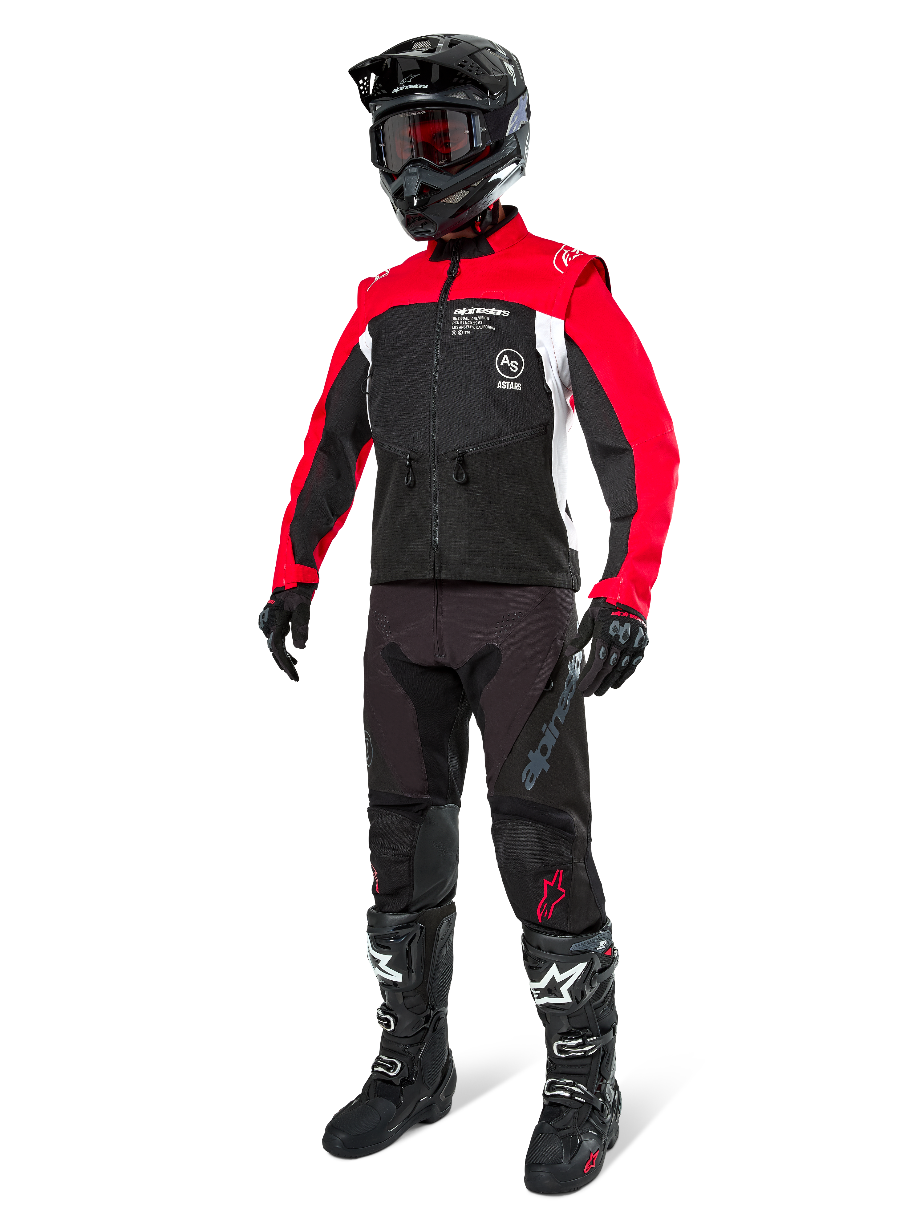 Alpinestars Pro-Dura Jacke, Offroad-Motorradjacke, Schwarz, Hellrot und Weiß, getragen mit kompletter Rennausrüstung inklusive schwarzem Helm mit roter Schutzbrille, schwarzer Hose und schwarz-weißen Stiefeln, strapazierfähiges Textil-Outfit für Enduro- und Trailfahrten