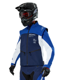 Alpinestars Lite-Dura Softshell Jacket, Navy, Bright Blue and White, Off-Road Enduro Jacket, worn with black helmet and red-tinted goggles, sporty color-block design with multiple zippers and brand logos, durable textile for motocross and trail riding
