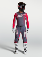 Alpinestars Supertech Hiten AFD Gear Set und Hose, professionelle Motocross-Bekleidung in Grau und Rot-Fluo, athletische Rennpassform für Elite-Fahrer.