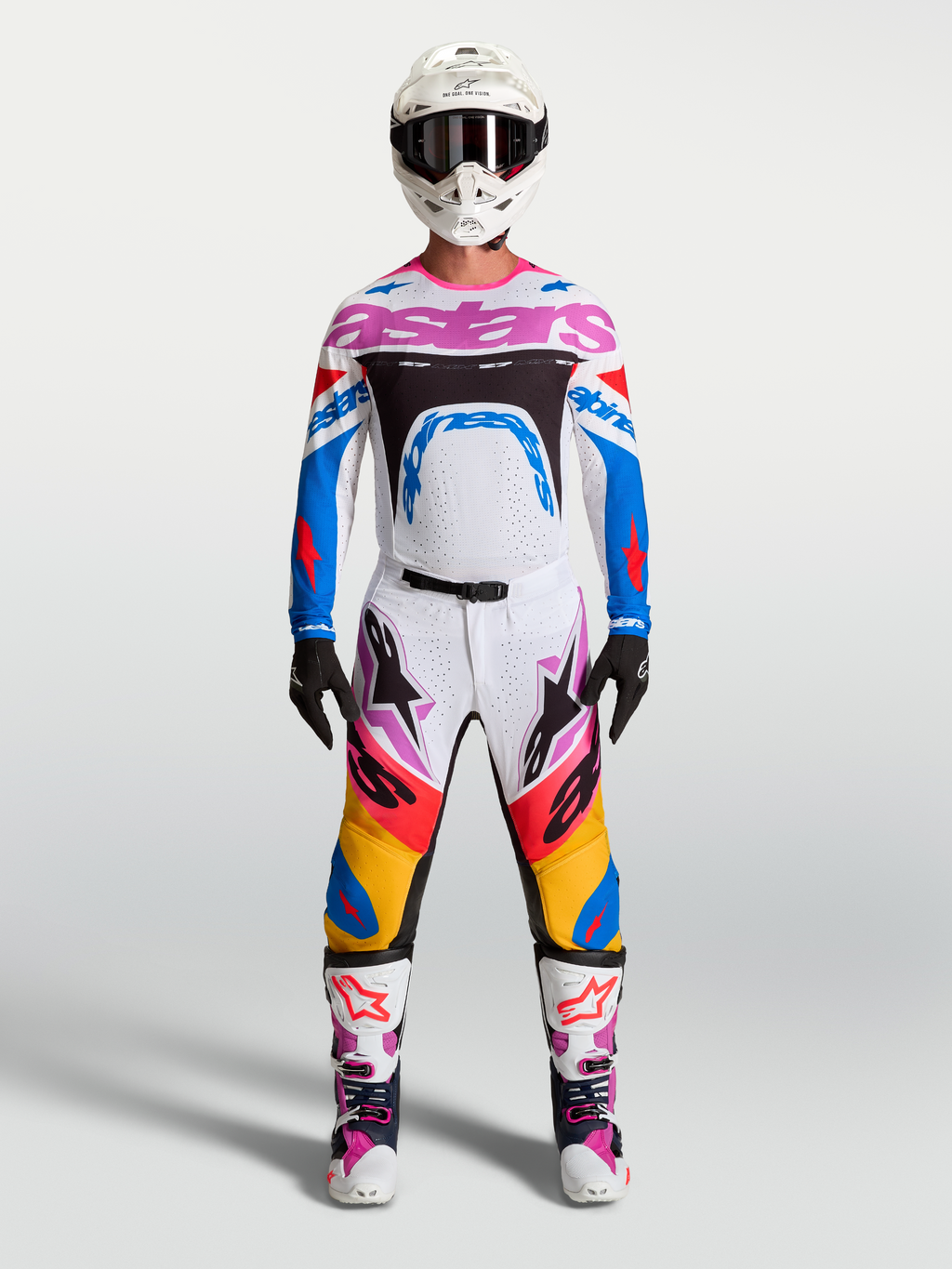 Alpinestars Supertech Dyna Hosen und Rennausrüstung, Herren-Motocross-Outfit in Weiß und Blau mit pinken Akzenten.