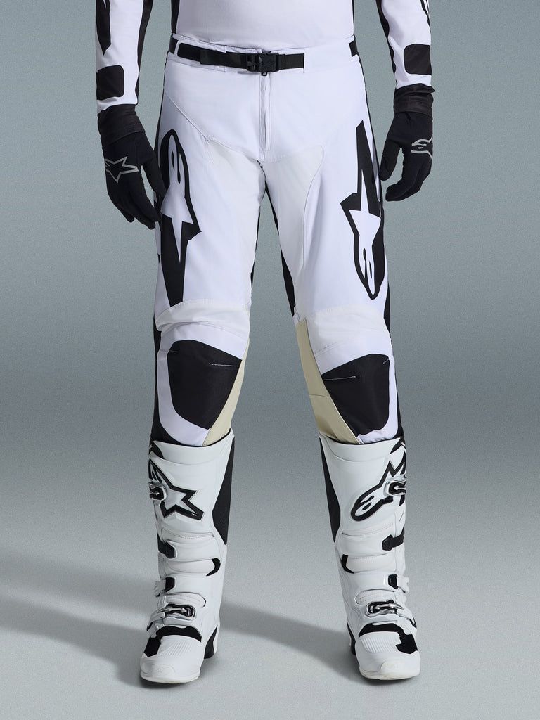 Alpinestars 2026 Racer Riway Pants, Motocross Pants, White and Black, worn with matching white and black motocross boots and black gloves, featuring bold black Alpinestars branding on the thighs, technical design for off-road performance.