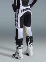 Alpinestars 2026 Racer Riway Pants, Motocross Pants, White and Black, back view showing bold black branding on the seat and sides, tan goat leather inner knee panels, worn with matching white and black motocross boots