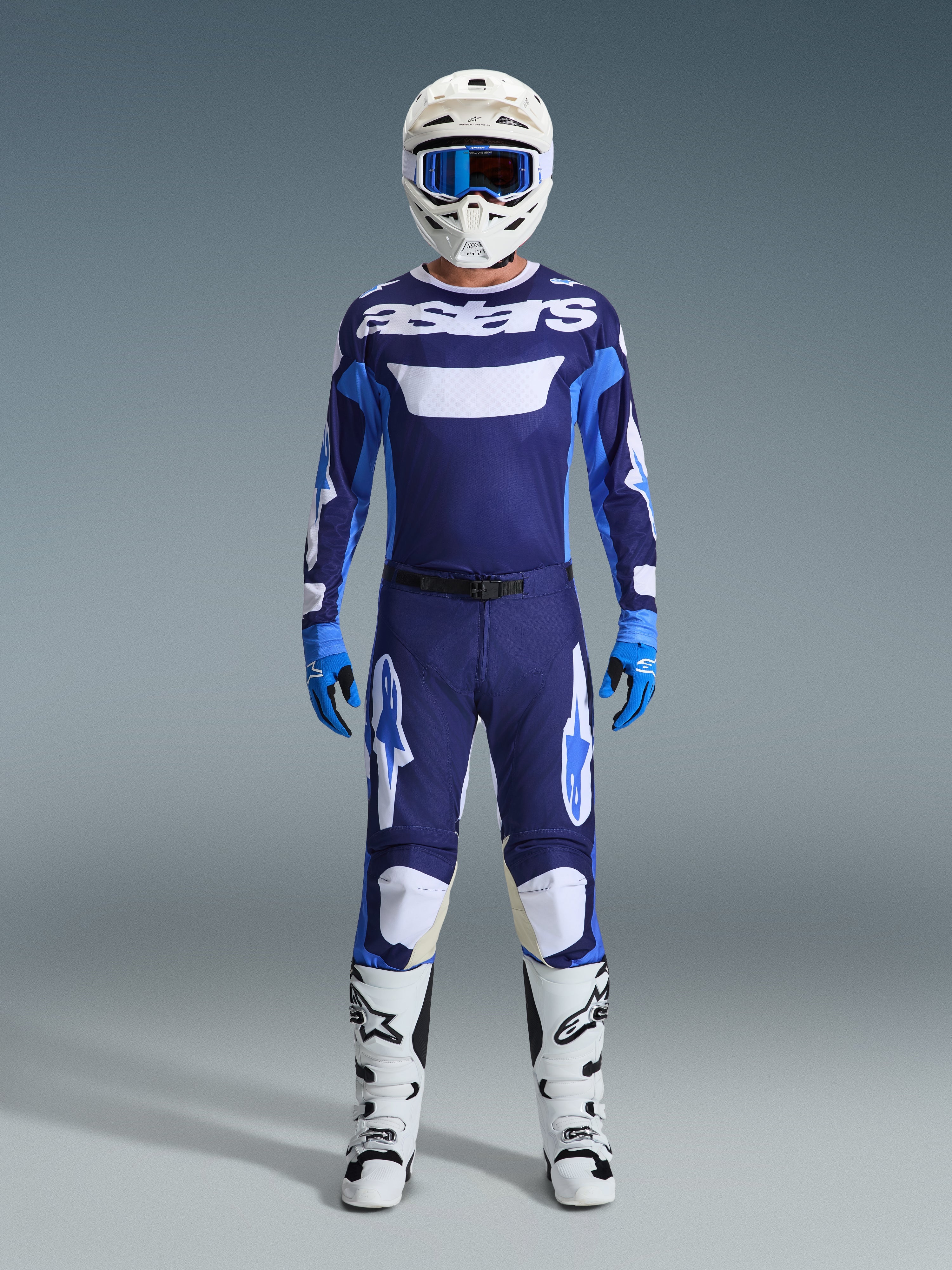 Alpinestars 2026 Racer Riway Gear Set, full motocross racing gear, Navy Blue and Light Blue jersey with white 'astars' text, matching pants with white accents, white helmet with blue goggles, and white off-road boots.