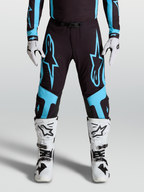 Alpinestars Supertech Vesta Hose, Motocross-Rennhose für Herren, Schwarz und Türkis mit großen Stern-Grafiken und Leder-Knie-Panels.