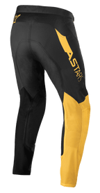 Alpinestars Supertech Blaze Hose, Motocross-Hose, Schwarz und Warm Yellow, Rückseitenansicht, mit markantem 'ASTARS'-Logo auf der Hüfte, gelben Einsätzen am Bein und technischem Stretch-Gewebe für Offroad-Performance.