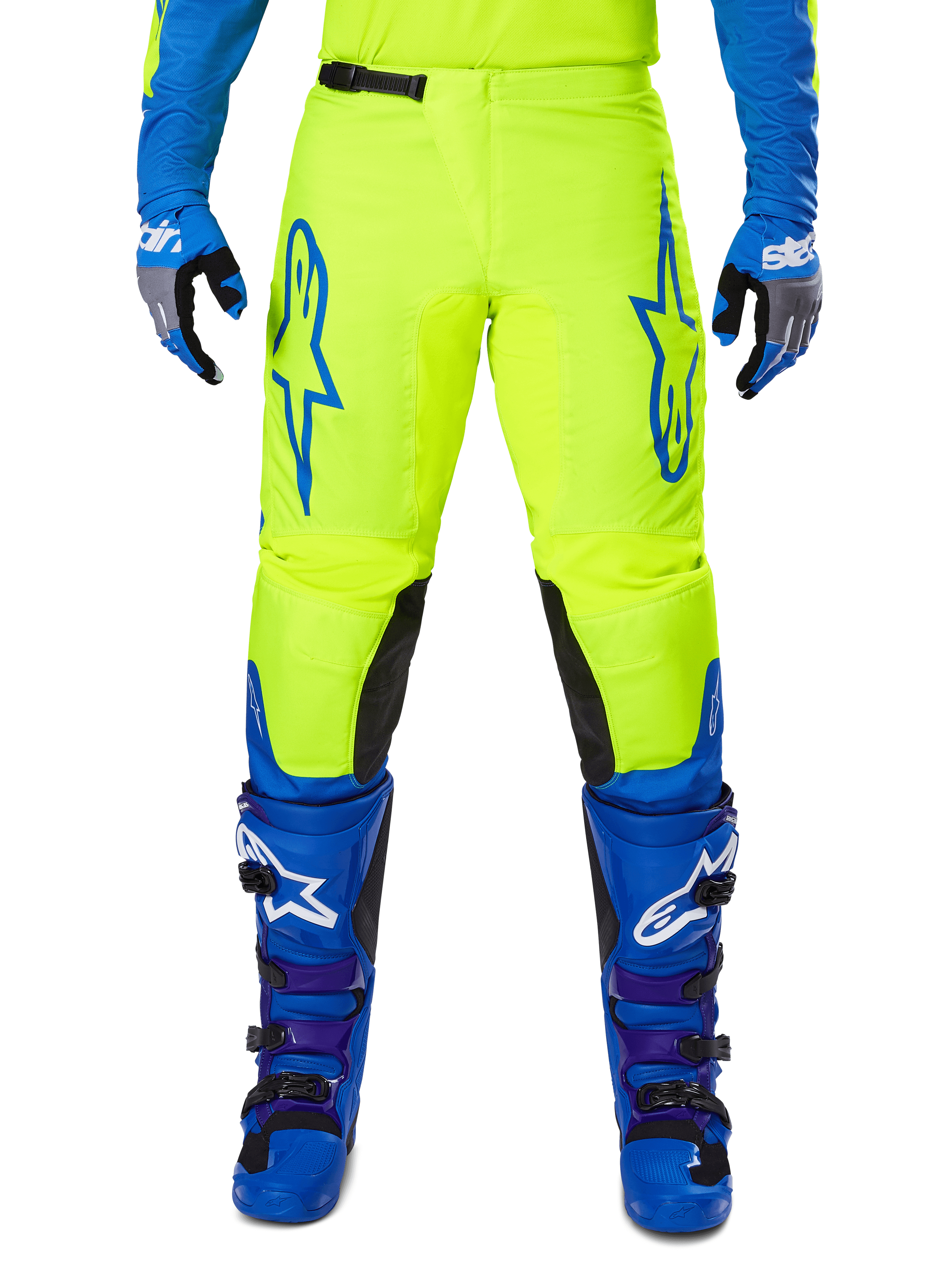Alpinestars 2025 Fluid Haul Hose, Motocross-Hose, Leuchtendes Gelb und Blau, getragen mit passenden Handschuhen und Stiefeln, schwarze Knieinnenseiten, markantes blaues Branding auf den Oberschenkeln, sportliches ergonomisches Design