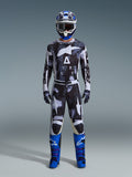 Alpinestars 2026 Racer Lahnd Gear Set, Motocross Outfit, Black and White with Iron Camo abstract pattern, paired with blue and white helmet and bright blue boots, complete racing kit for off-road performance