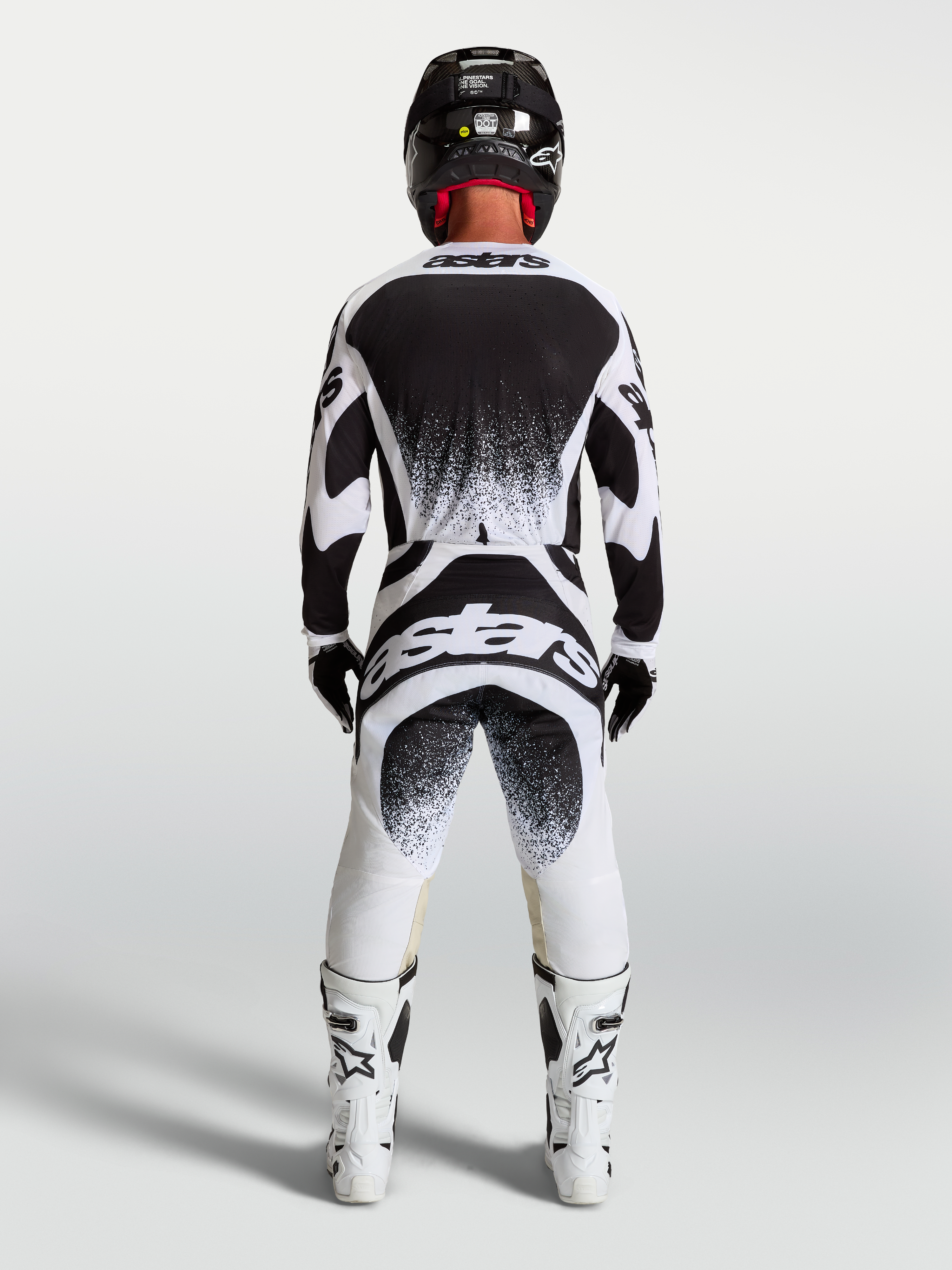 Alpinestars Techstar Swan Trikot und Hose, Herren-Motocross-Ausrüstung in Schwarz und Weiß, Rückansicht mit Branding.