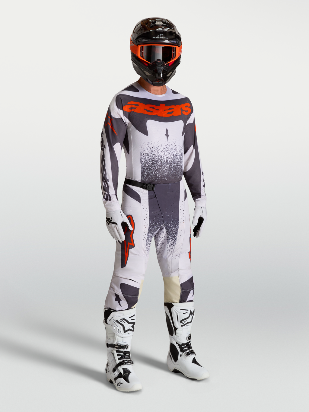Alpinestars Techstar Swan Motocross-Set für Herren, Trikot und Hose in Helllila und Leuchtrot mit weißen Stiefeln.