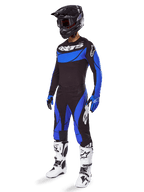 Alpinestars 2025 Techstar Dreem Gear Set, Motocross gear in Black and Blue, including jersey and pants with white branding, worn with a black helmet, blue and black gloves, and white and black boots, complete coordinated racing outfit for off-road performance.