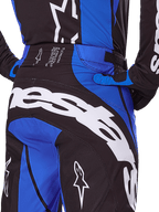Alpinestars 2025 Techstar Dreem Pants, Motocross Pants, Black and Blue, rear view showing bold white branding across the seat, blue accents and Techstar waistband detail, coordinated with matching jersey and gloves