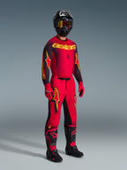 Alpinestars 2026 Supertech Scenz Pants, Motocross Pants, Red Black and Yellow, worn by a rider in a complete racing gear set with matching jersey and boots, featuring bold yellow and black star logos and an athletic fit.