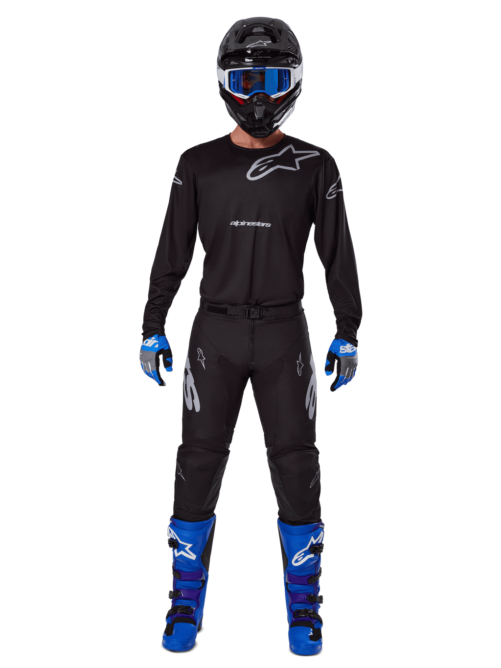 Alpinestars 2025 Racer Graphite Pants, Motocross Pants, Black and Gray, worn on a model with a matching black jersey, blue and purple boots, and blue goggles, complete off-road racing outfit featuring bold Alpinestars branding
