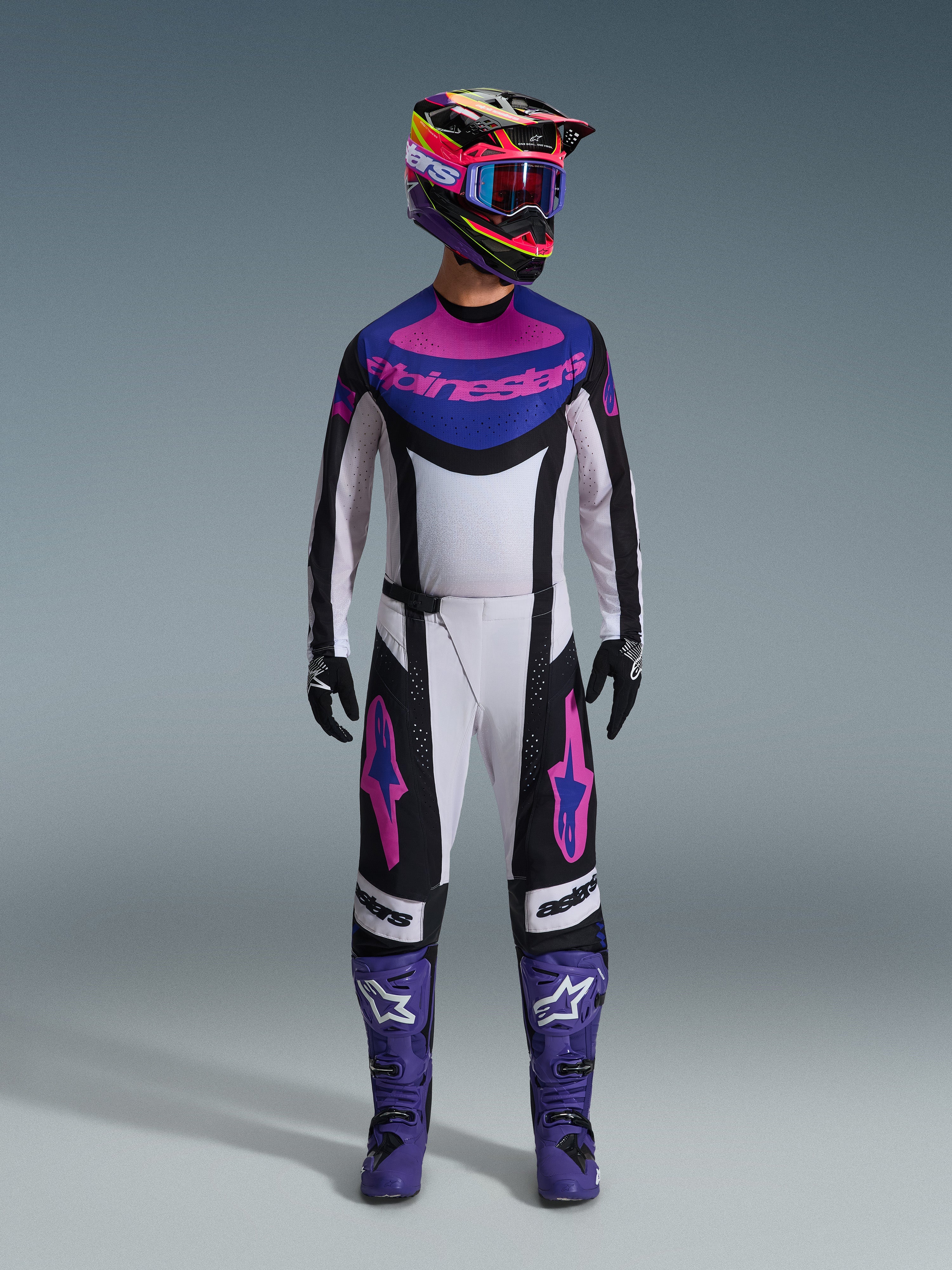 Alpinestars 2026 Techstar Knif Gear Set, Motocross-Komplettausrüstung, Weiß, Schwarz, Lila und Pink, getragen mit einem mehrfarbigen Helm, blauer Brille, lila Stiefeln und schwarzen Handschuhen, abgestimmtes Hochleistungs-Set für den Offroad-Rennsport