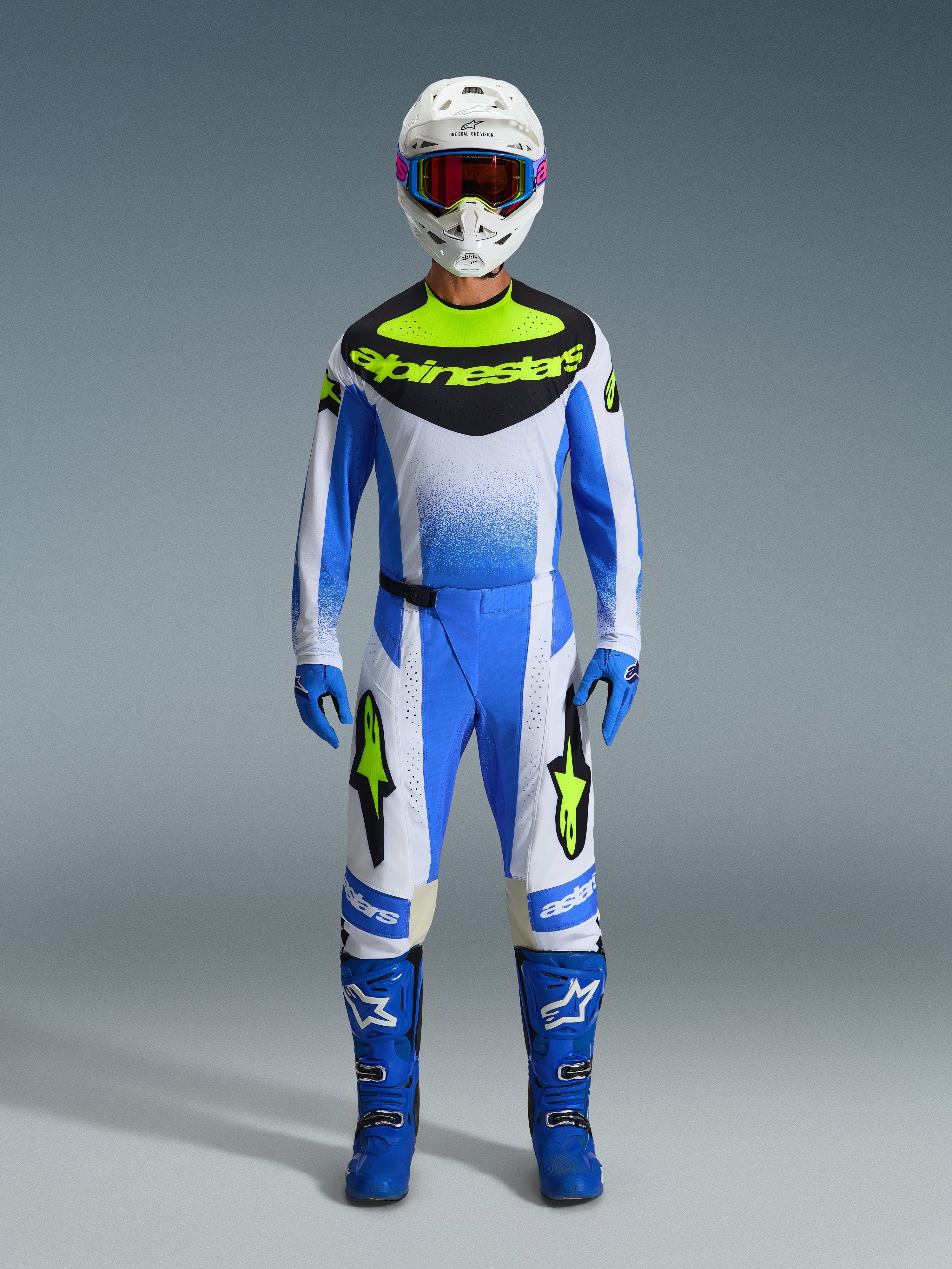 Alpinestars 2026 Techstar Knif Gear Set, Motocross Racing Outfit in Blue, White, and Yellow Fluo, full body shot of rider wearing matching jersey and pants with white helmet, blue goggles, and blue racing boots, coordinated off-road competition kit