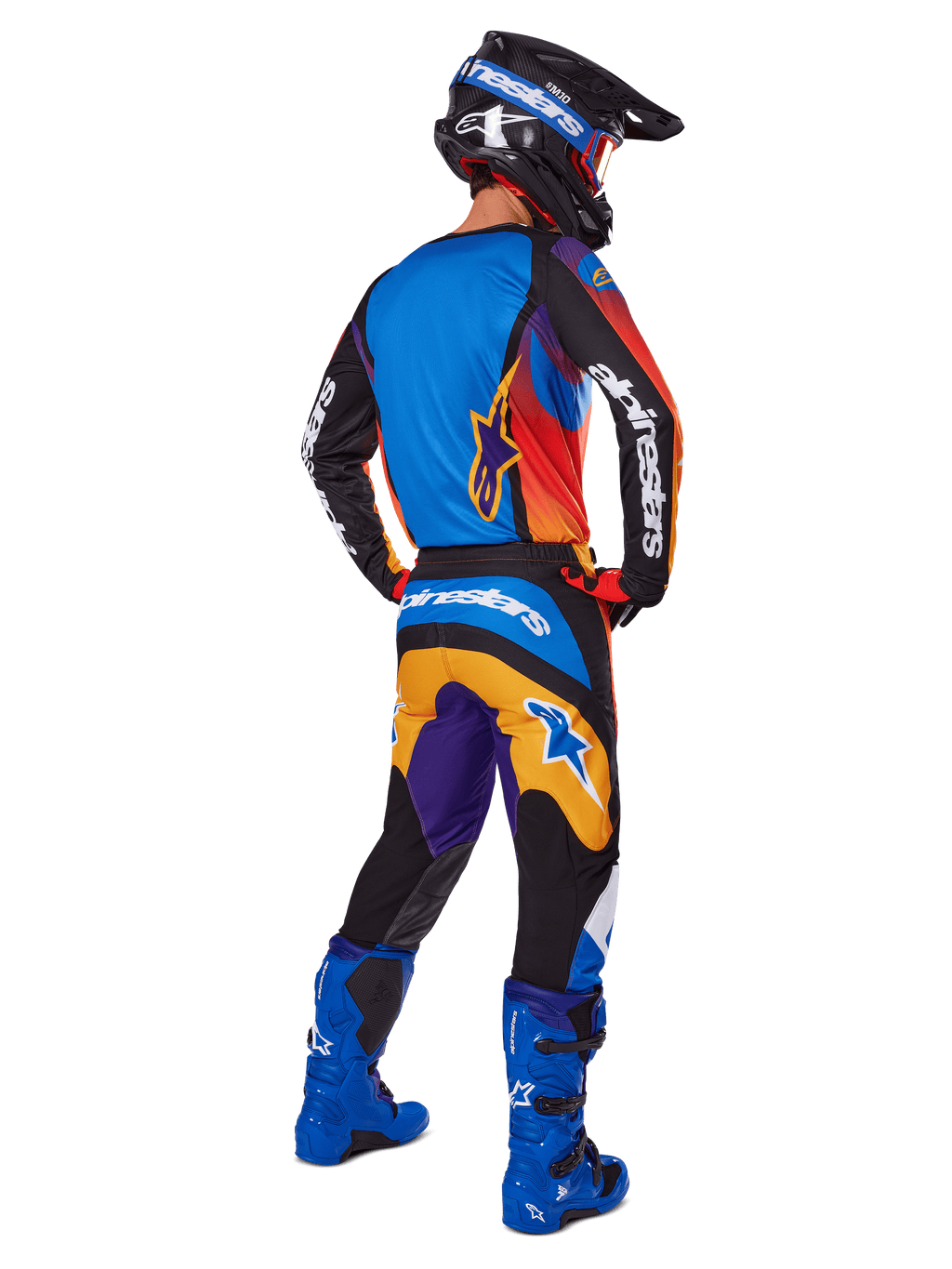 Motocross rider from the back wearing Alpinestars 2025 Fluid Wurx Pants, Multicolor design with blue, orange, yellow, and purple accents, paired with a matching jersey, bright blue boots, and black helmet, complete off-road racing gear.