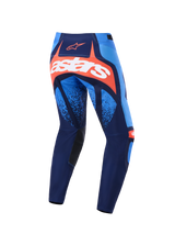 Alpinestars 2026 Techstar Nomur Pants, Motocross Pants, Dark Navy, Orange, and UCLA Blue, back view featuring a bold white astars logo on an orange panel, multi-panel design with light blue accents, black inner knee panels, durable gear for off-road racing.