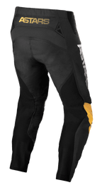 Alpinestars Techstar Quadro Hose, Motocross-Hose, Schwarz, Gelb und Tangerine, Rückansicht mit gelbem „ASTARS“-Branding am Bund, schwarzen Mesh-Einsätzen zur Belüftung und ergonomischen Knieeinsätzen in Gelb und Tangerine für Langlebigkeit beim Offroad-Rennsport.