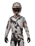 Alpinestars 2024 Racer Tactical Jersey, Motocross-Trikot, Iron Camo Dust Gray Tarnmuster, Fahrer mit passendem Helm und Schutzbrille sowie schwarzen Handschuhen, technische Ausrüstung für den Offroad-Rennsport