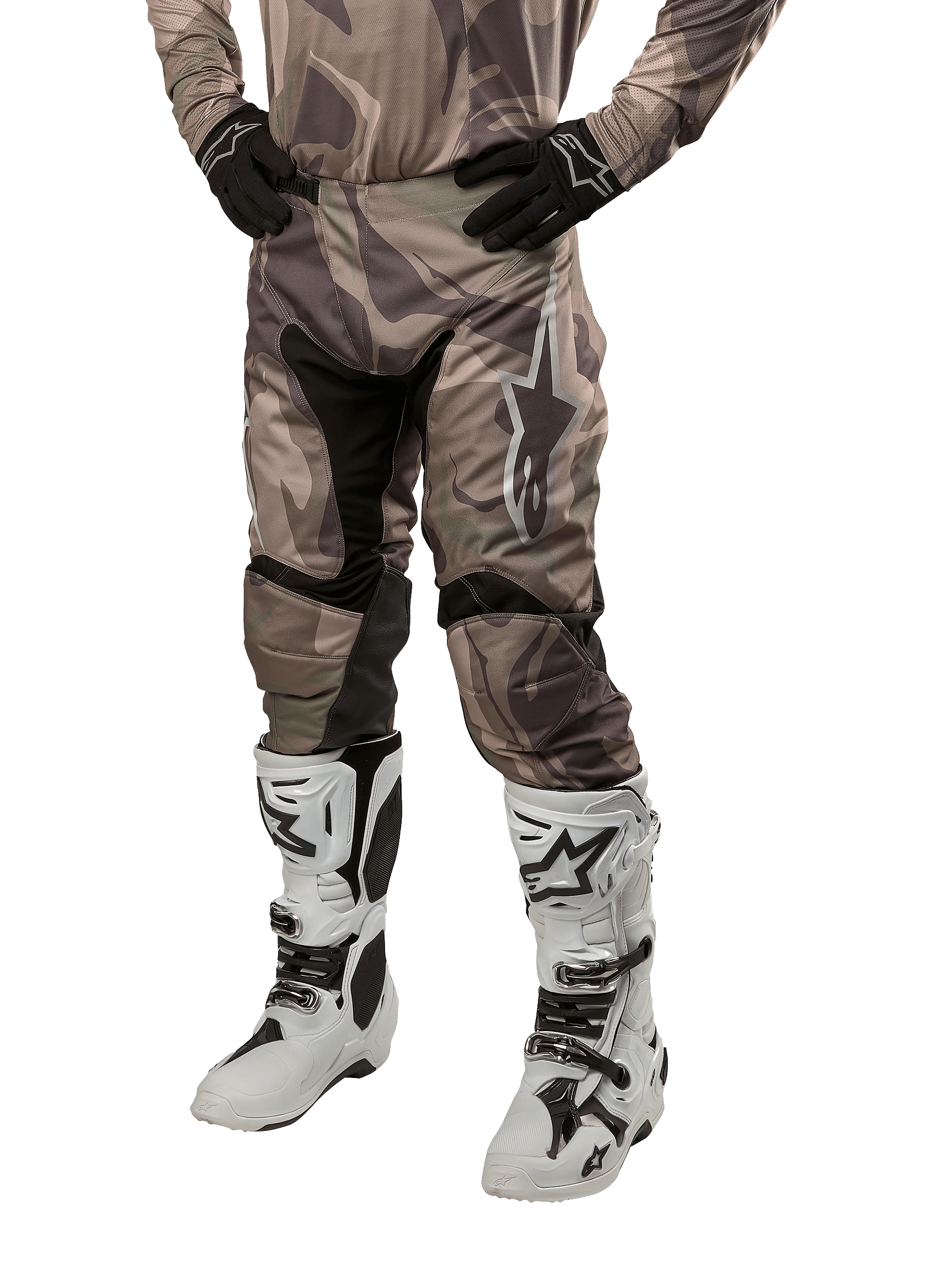 Alpinestars 2024 Racer Tactical Hose, Motocross-Hose, Militärgrün Camo Braun, getragen mit passendem Camouflage-Trikot, schwarzen Handschuhen und weißen Stiefeln mit Stern-Logos, mit schwarzen Stretch-Einsätzen und ergonomischem Design, Offroad-Ausrüstung auf weißem Hintergrund