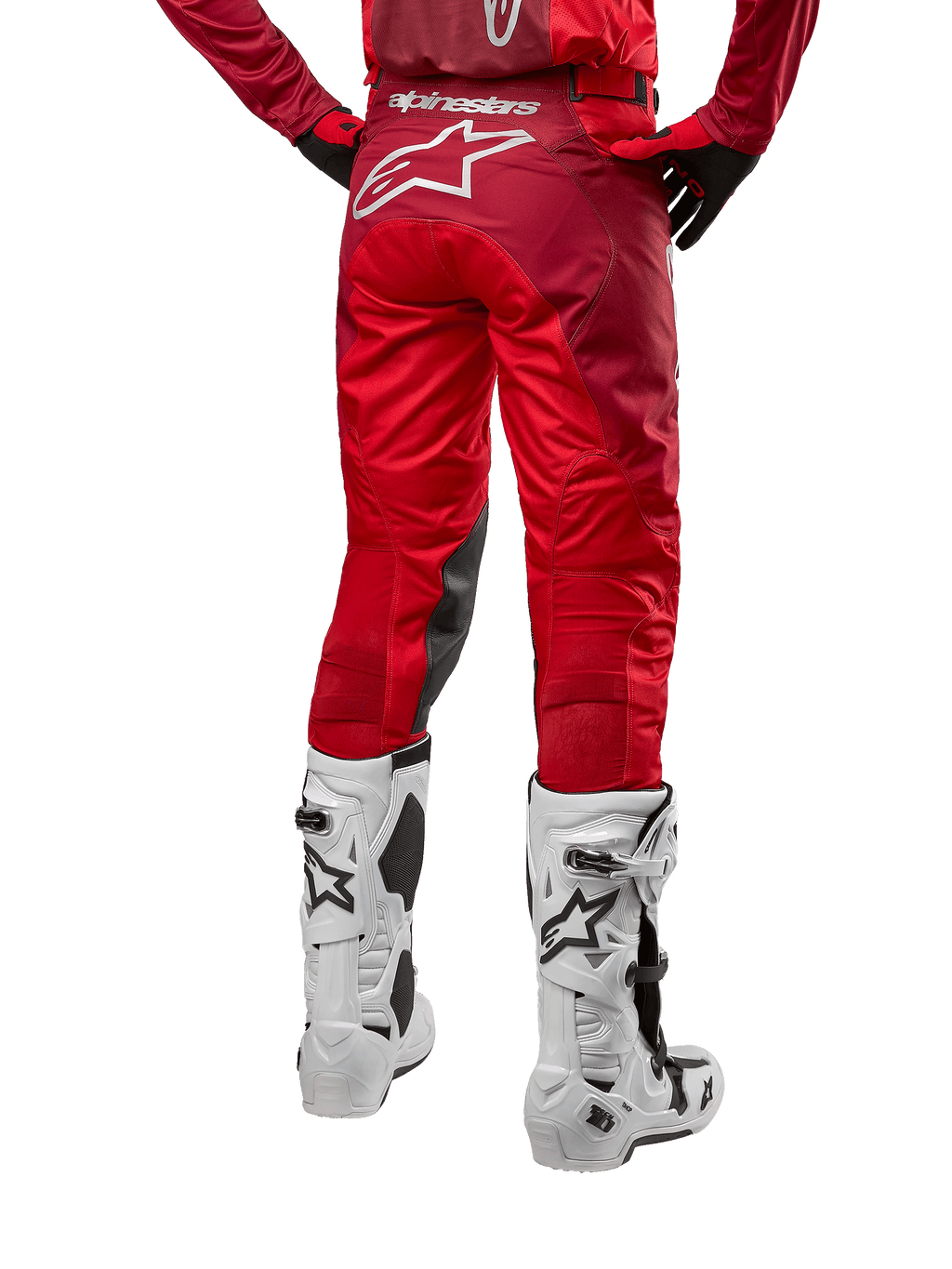 Alpinestars 2024 Racer Hoen Hose, Motocross-Hose, Mars Red Burgundy, Rückansicht mit großem weißem Astar-Logo auf der Rückseite, schwarze Knie-Innenpaneele, getragen mit weißen Motocross-Stiefeln, Hochleistungs-Offroad-Ausrüstung