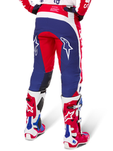 Alpinestars Limited Edition Techstar Fortitude Pants, Motocross Pants, Red White and Blue, back view worn with matching red and white boots, featuring white star logos on the thighs, durable multi-panel design for professional off-road racing.