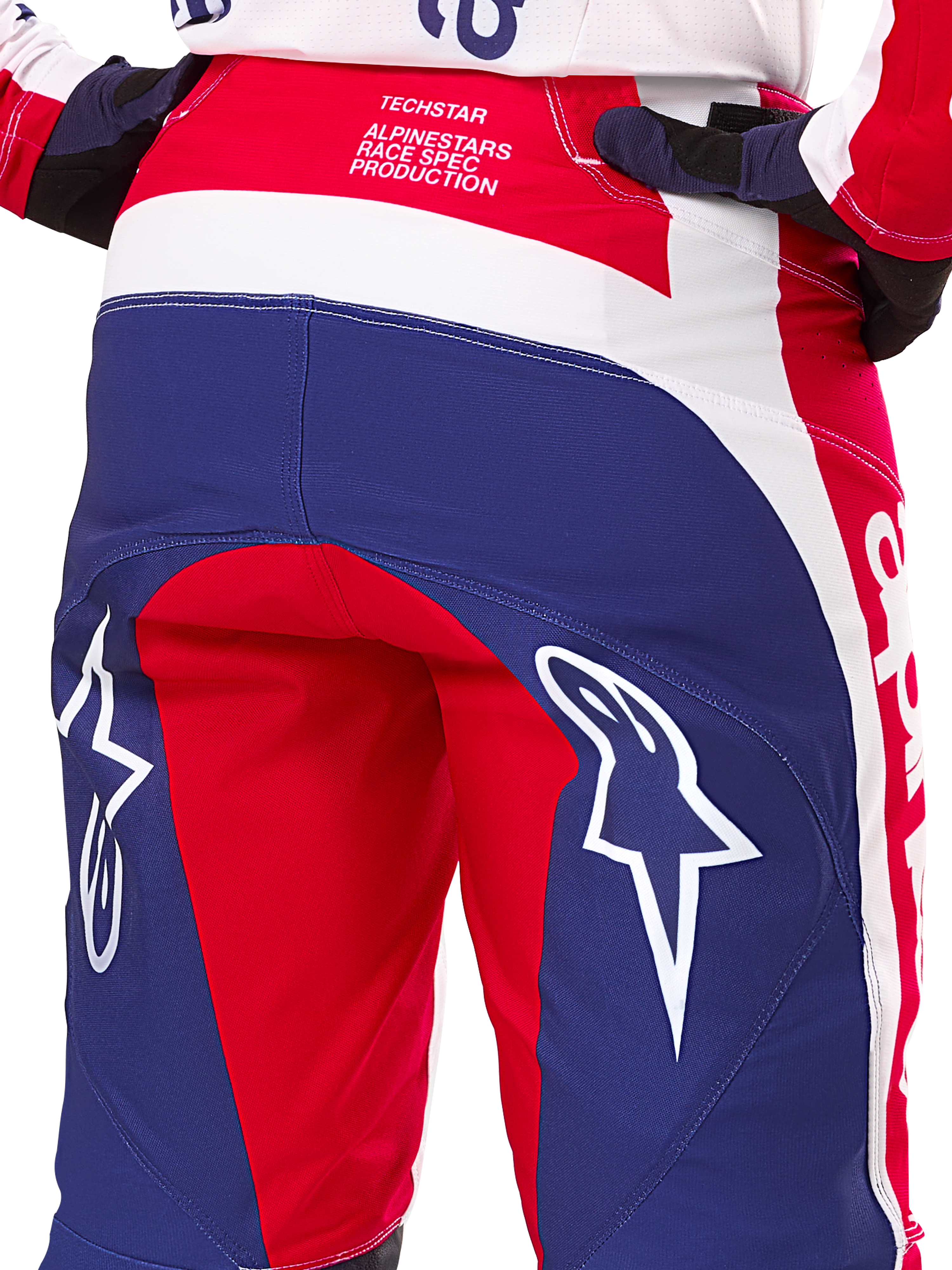 Alpinestars Limited Edition Techstar Fortitude Pants, Motocross Pants, Red White and Blue, Rear view featuring large white star logos on the seat and Techstar Race Spec branding, durable performance textiles for off-road racing