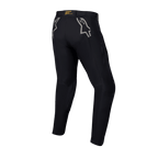 Alpinestars Techdura Hose, schwarze Enduro- und Offroad-Hose, Rückansicht mit grauen Stern-Logos auf den Hüften, gelbes Branding am hinteren Bund, robustes Stretch-Polyamid-Material mit strapazierfähigem Design für Motorradfahrten