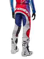Alpinestars 2024 Techstar Pneuma Pants, Motocross Pants, Blu Mars Red White, rear view worn with matching jersey and white boots, featuring bold white branding on the seat and multi-color paneling, professional motocross racing apparel