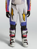 Alpinestars Fluid Drag Jugend-Hose 2027, weiße und blaue Motocross-Hose mit goldfarbenen Grafiken, ideal für Offroad-Rennen.