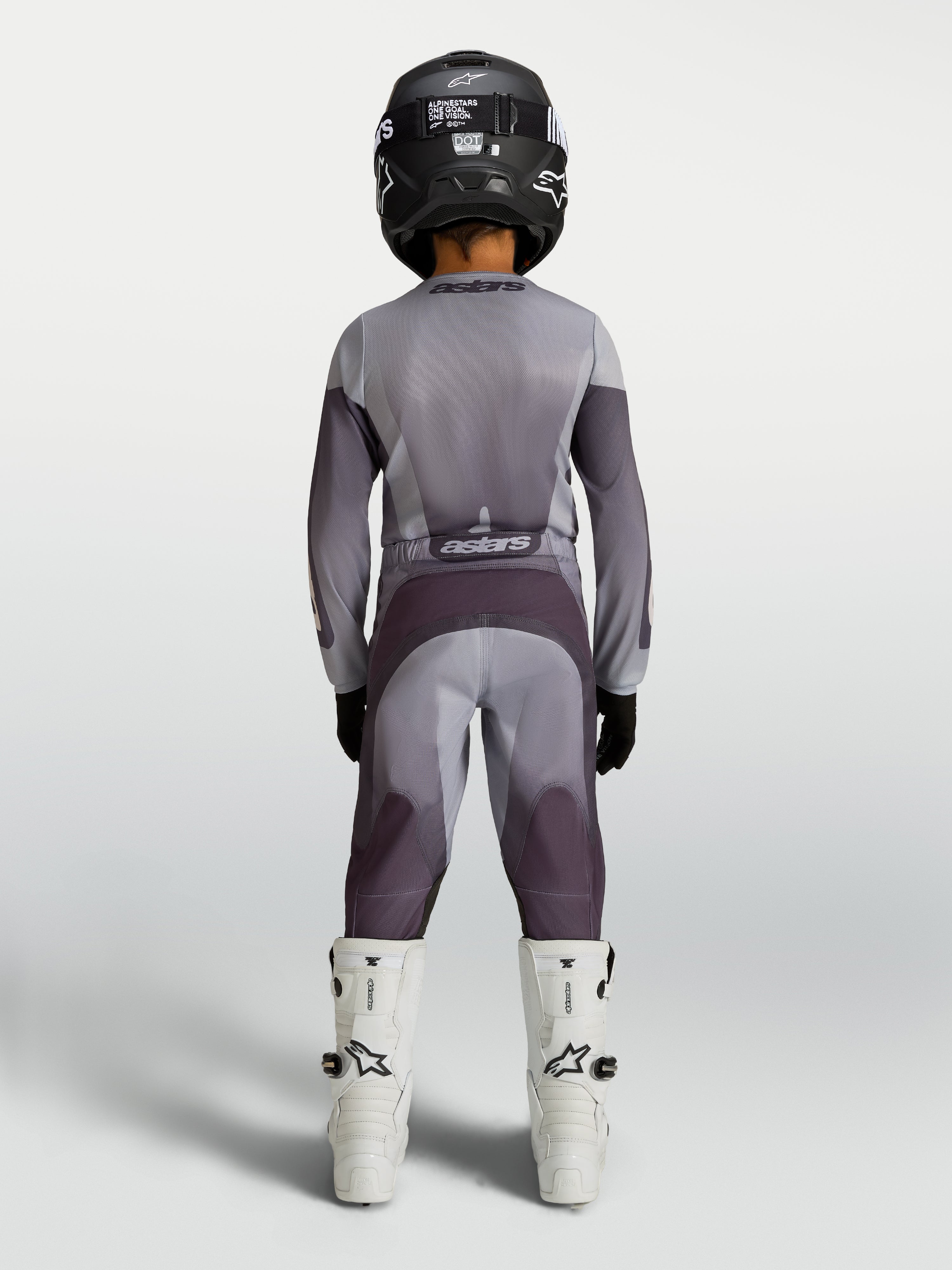 Alpinestars Fluid Jugend-Hose Amber in Sand und Grau, strapazierfähige MX-Hose für Kinder, Rückansicht auf einem Fahrer.