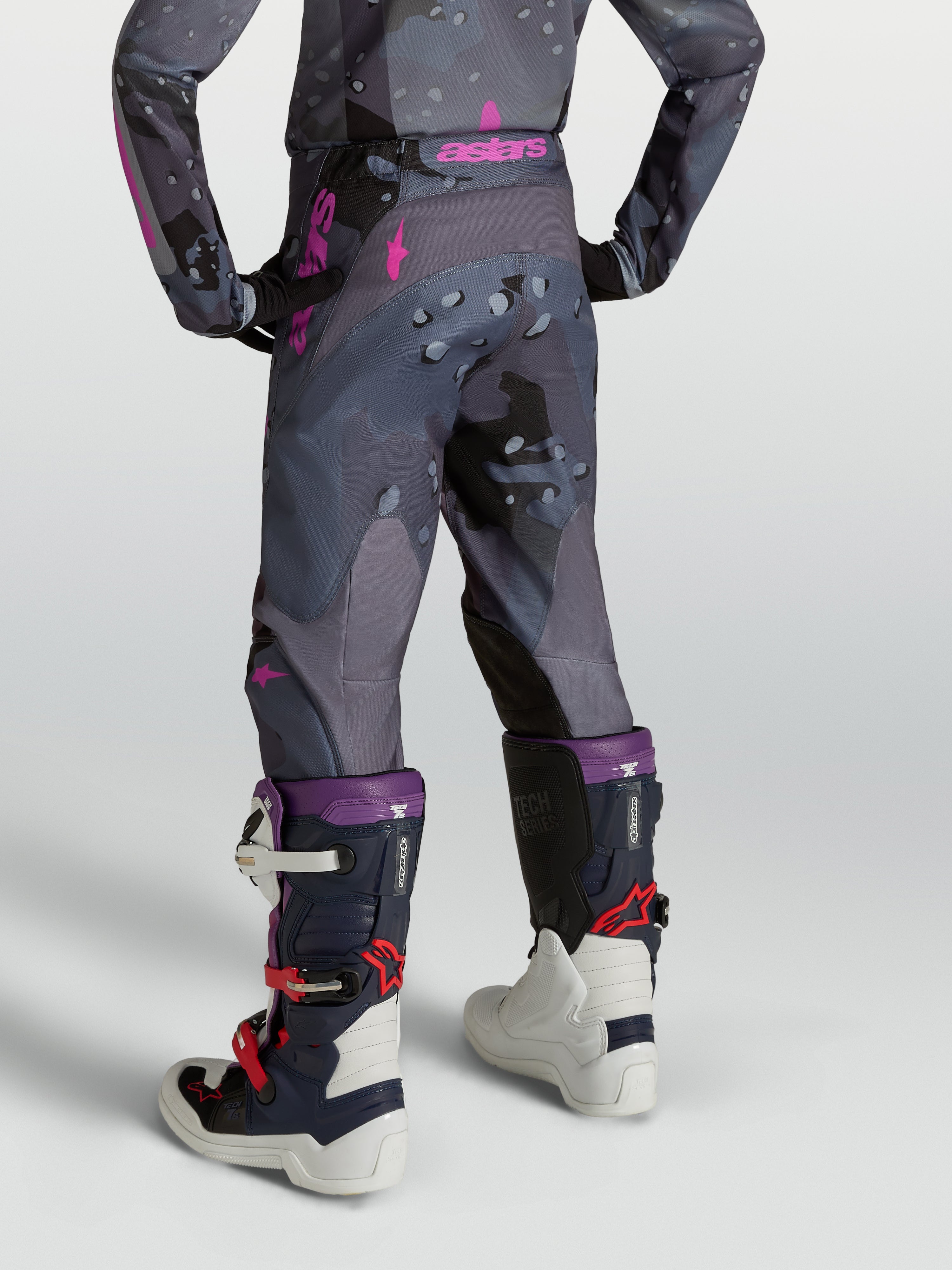 Alpinestars Jugend Fluid Lone Hose, Motocross-Hose in grauem Camouflage und Lila mit ergonomischer 3D-Passform, Rückansicht am Model.