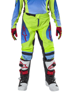 Alpinestars Jugend 2024 Racer Hoen Hose, Motocross-Hose, Gelb Fluo und Blau Night Navy, mit roten Stern-Logos auf den Oberschenkeln, kombiniert mit passendem Trikot, rot-schwarzen Handschuhen und weiß-schwarz-roten Motocross-Stiefeln, strapazierfähige Ausrüstung für den Offroad-Einsatz