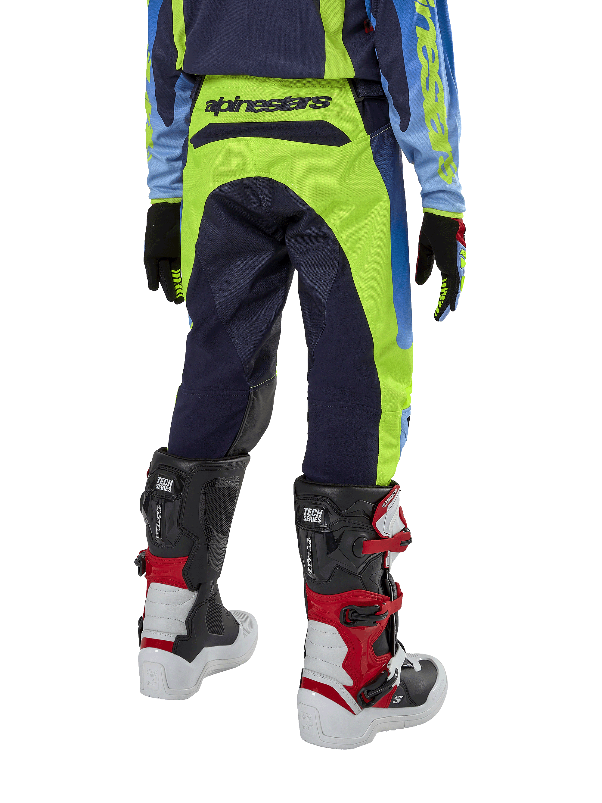 Alpinestars Youth 2024 Racer Hoen Hose, Motocross-Hose, Gelb Fluo und Blue Night Navy, Rückansicht mit markantem Alpinestars-Branding am Bund, getragen mit schwarz-roten Tech Series Stiefeln und passendem Trikot, strapazierfähige sportliche Passform für jugendliche Offroad-Fahrten