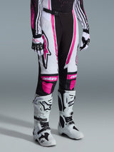Alpinestars 2026 Woman Stella Techstar Nomur Pants, Motocross Pants, Black White Fuchsia, worn with matching jersey, gloves and white racing boots, featuring pink accents and white side panels with the Astars logo, ergonomic women-specific design for off-road performance