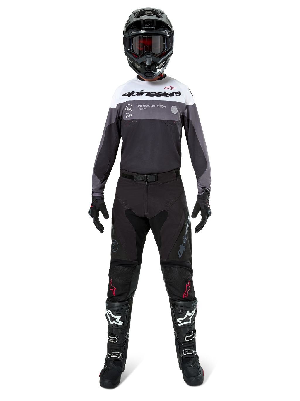 Motocross-Fahrer in kompletter Rennausrüstung, Pro-Dura Trikot in Black Magnet White mit weißem Brustbereich und grauen Akzenten, kombiniert mit schwarzer Hose, schwarzem Helm mit dunkler Brille, weiß-schwarzen Stiefeln und schwarzen Handschuhen, abgestimmtes Outfit für Enduro- und Offroad-Rennsport