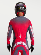Alpinestars Supertech Hiten AFD Trikot, Motocross-Rennsport, Rückansicht, Grau und Fluo-Rot, belüftete Mesh-Konstruktion.